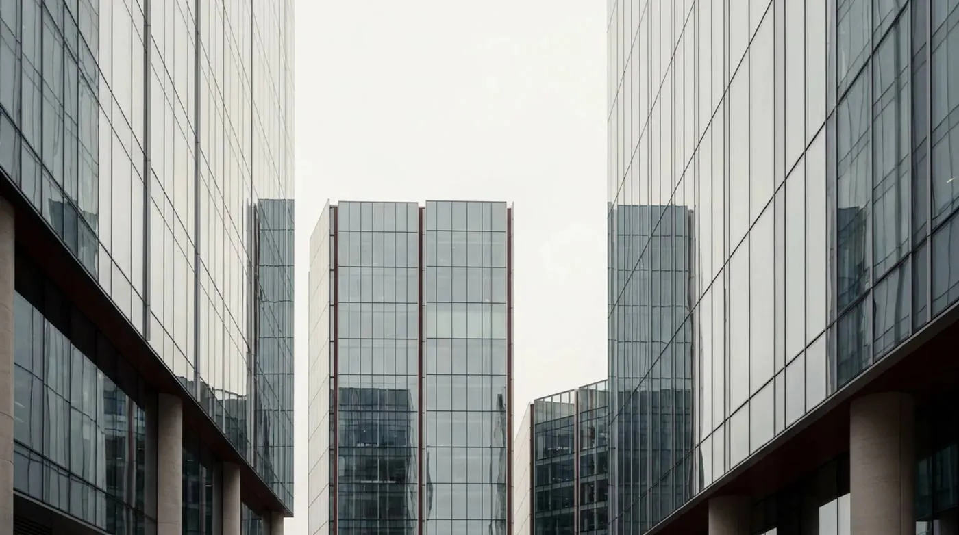 Minimal glass office towers under an overcast sky